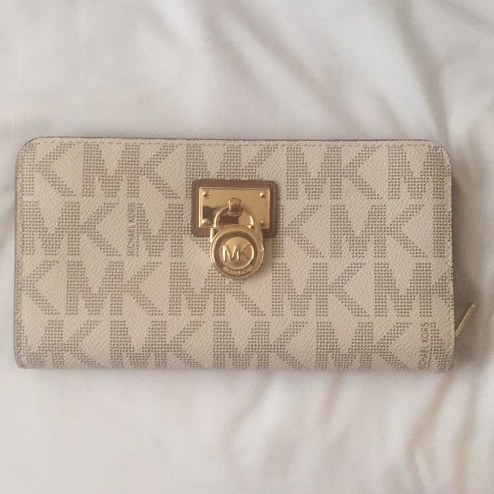 Brown and white michael kors wallet